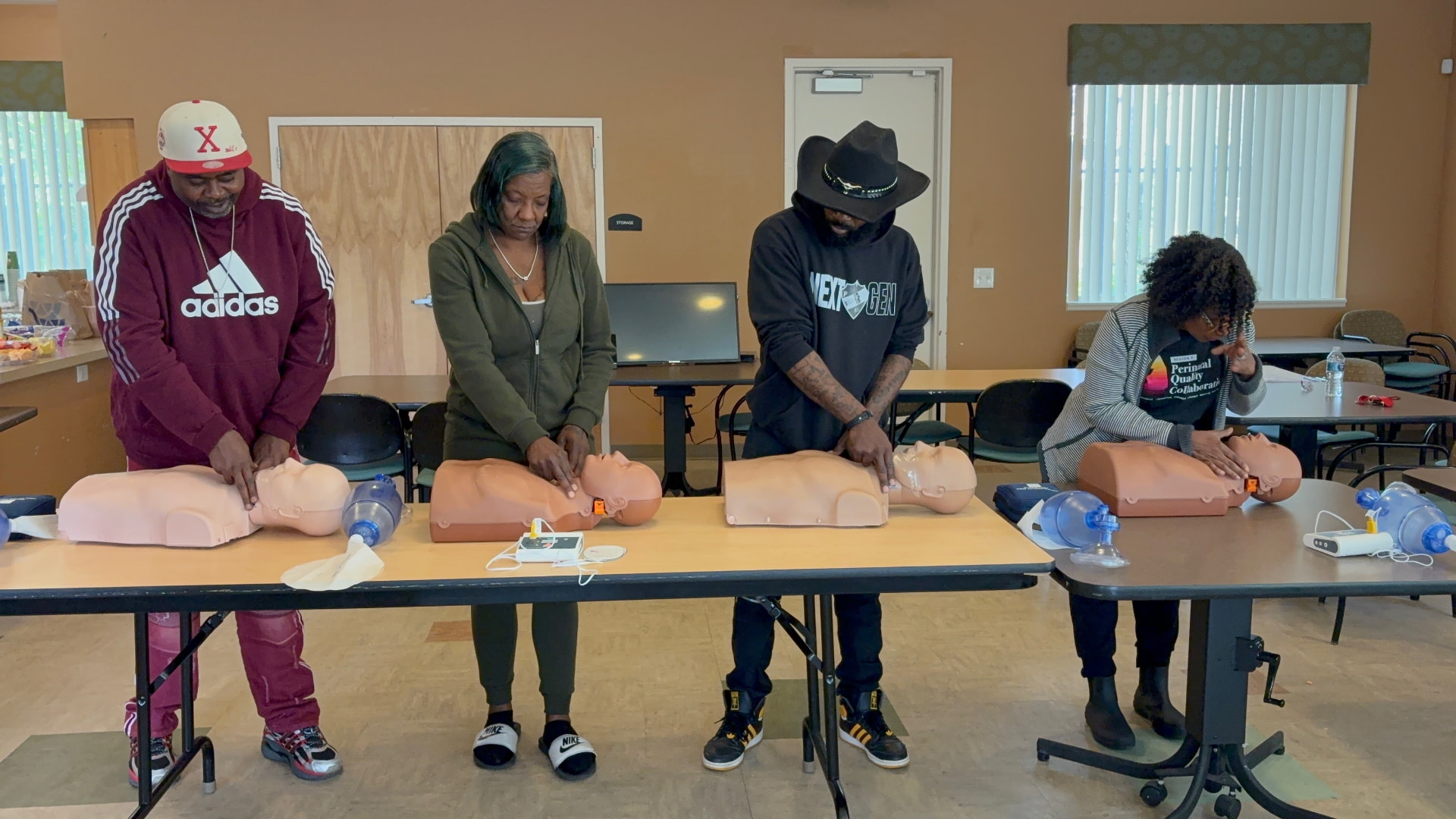 Community members completing hands-on CPR certification training